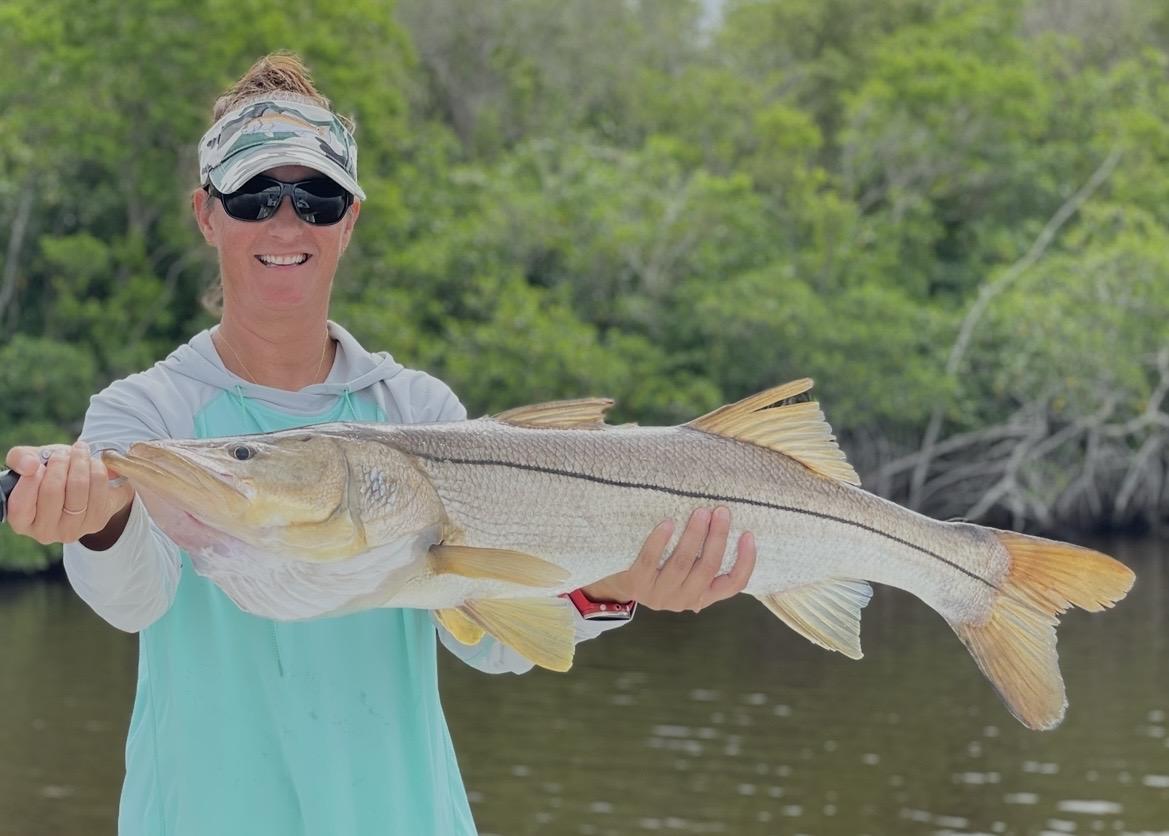 Angler holding a redfish caught on an A2 Fishing Charters trip in the Everglades